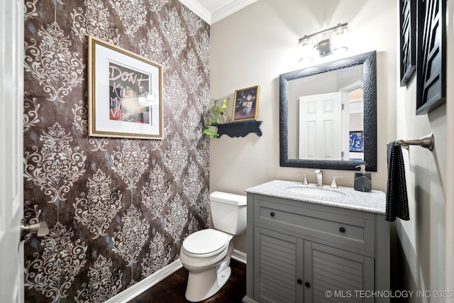 bathroom featuring crown molding, vanity, toilet, and wood-type flooring