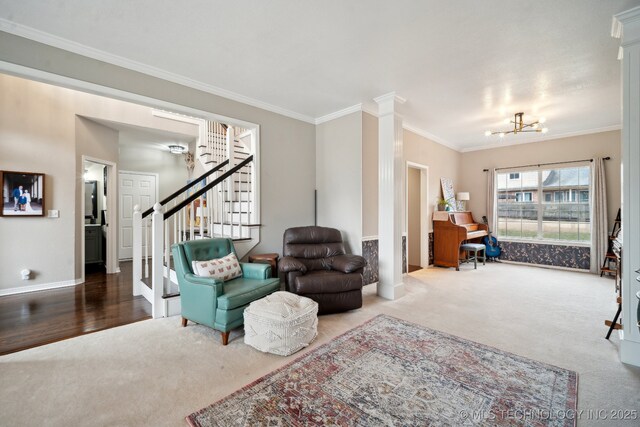 carpeted living room with an inviting chandelier, ornamental molding, and decorative columns