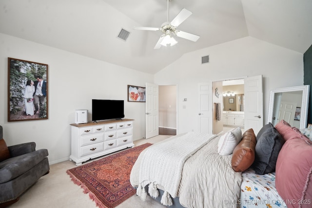 carpeted bedroom featuring ceiling fan, connected bathroom, and vaulted ceiling