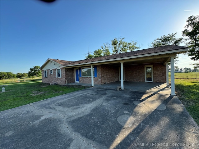 single story home featuring a carport and a front yard