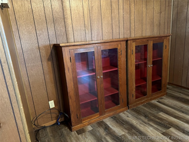 details featuring hardwood / wood-style floors and wooden walls