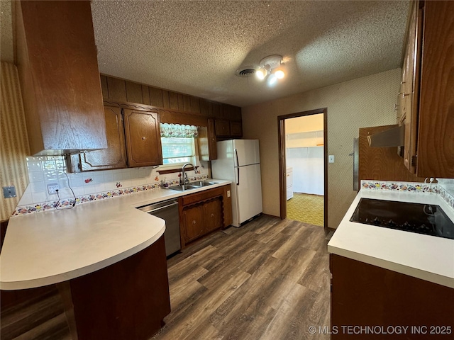 kitchen with sink, white refrigerator, stainless steel dishwasher, dark hardwood / wood-style flooring, and black electric stovetop