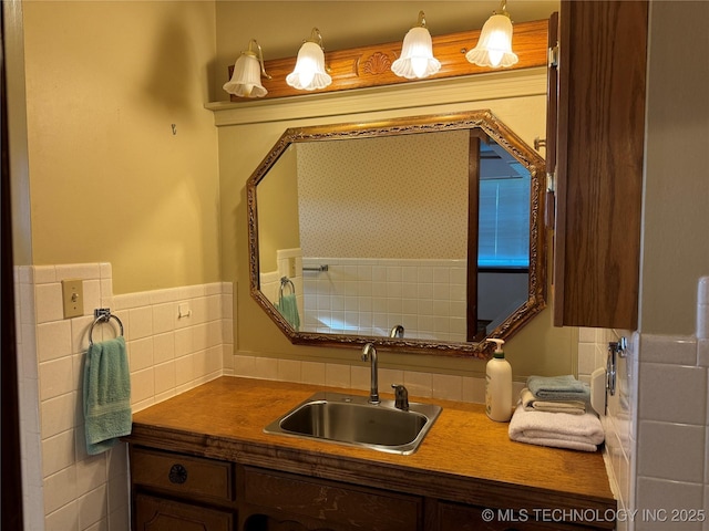 bathroom featuring vanity and tile walls