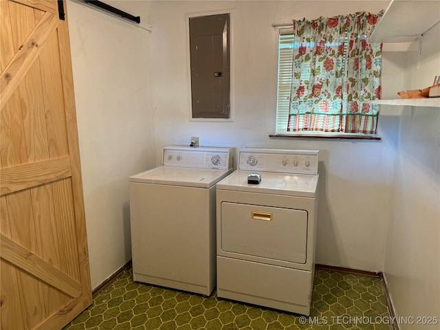 washroom featuring washer and dryer, electric panel, and a barn door