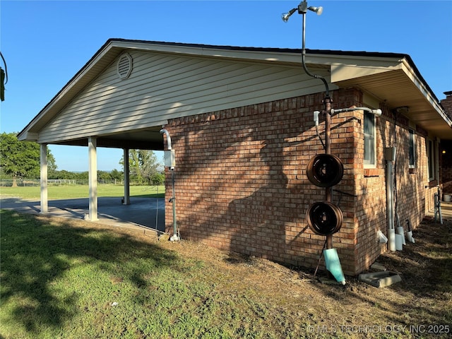 view of side of home with a lawn