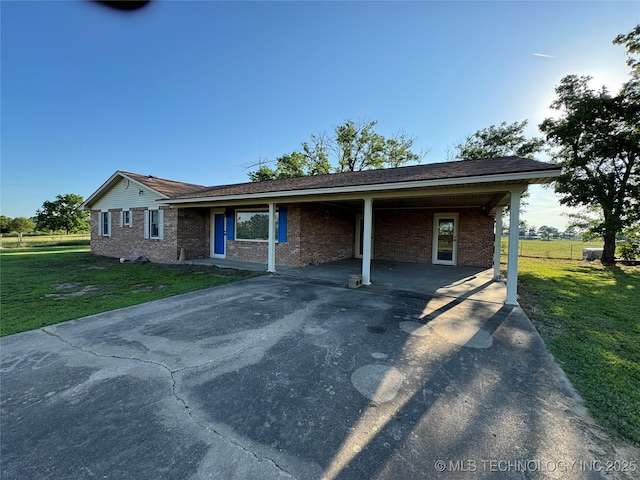 ranch-style home with a carport and a front lawn