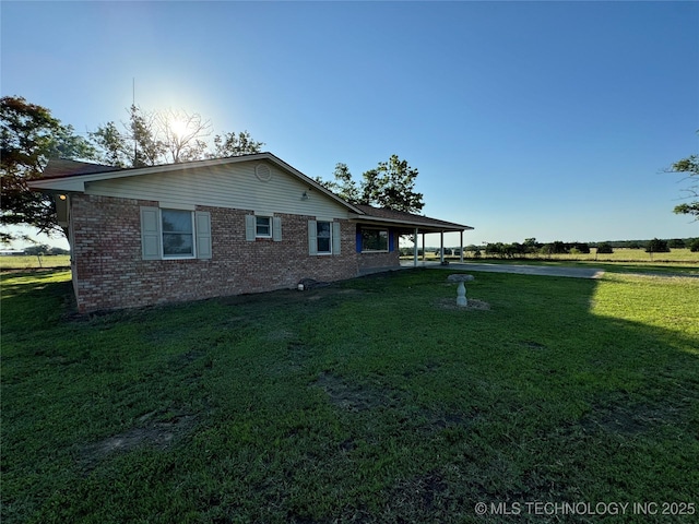 view of side of home featuring a yard