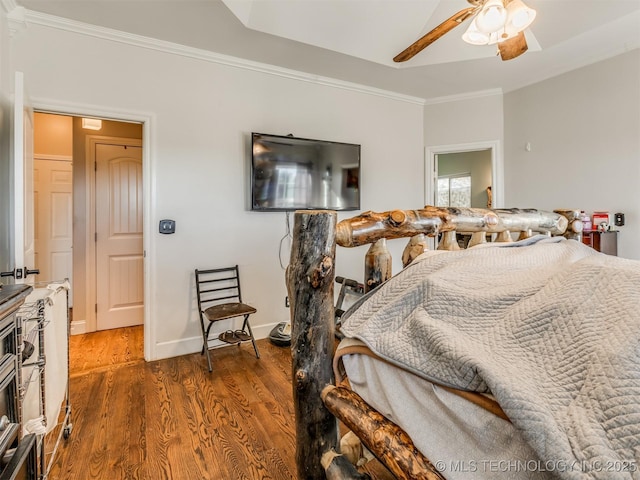 bedroom with ornamental molding, dark hardwood / wood-style floors, and ceiling fan