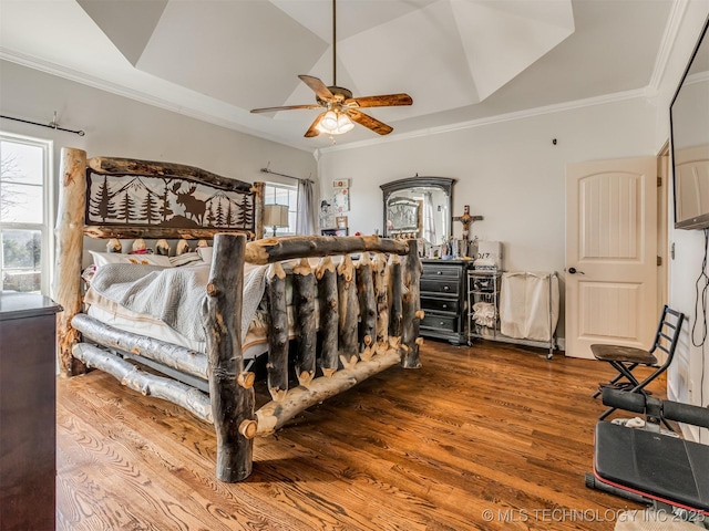 bedroom featuring ceiling fan, ornamental molding, and hardwood / wood-style floors