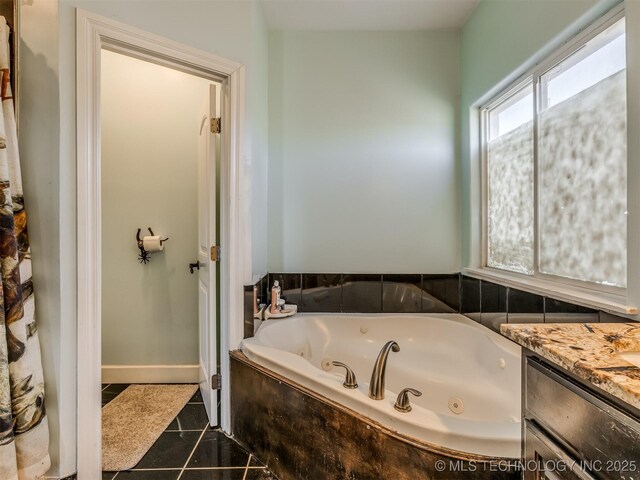 bathroom with vanity and tiled tub