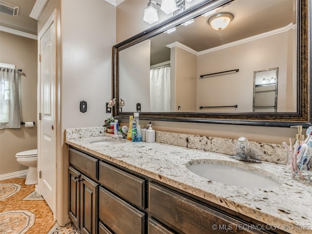 bathroom with crown molding, vanity, toilet, and tile patterned flooring