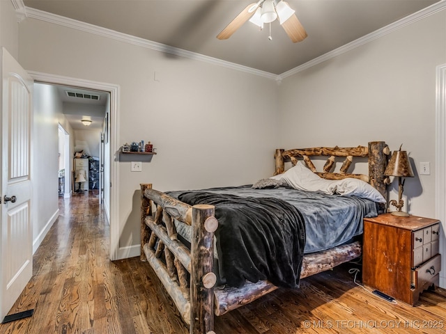 bedroom featuring hardwood / wood-style floors, ornamental molding, and ceiling fan