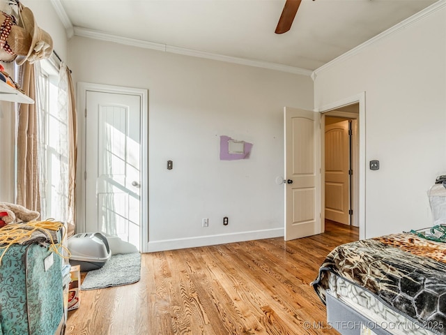 bedroom featuring hardwood / wood-style floors, ornamental molding, and ceiling fan