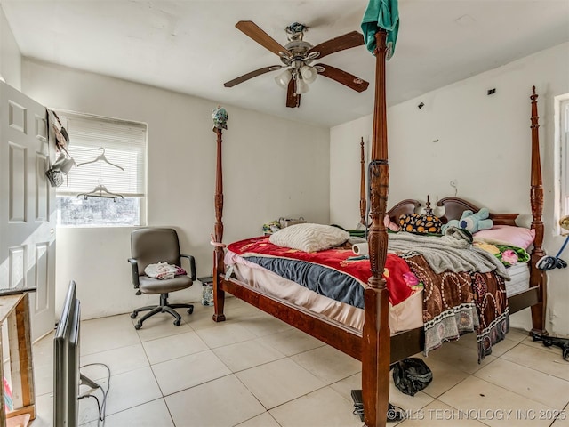 tiled bedroom featuring ceiling fan