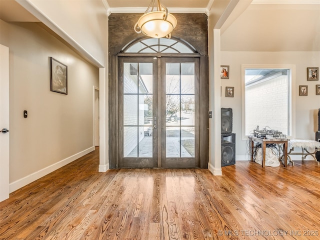 doorway featuring crown molding, hardwood / wood-style floors, and french doors