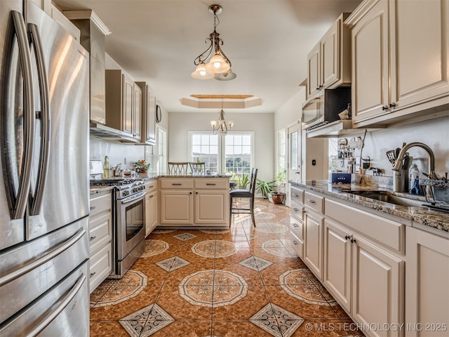 kitchen featuring appliances with stainless steel finishes, pendant lighting, sink, light tile patterned floors, and light stone countertops