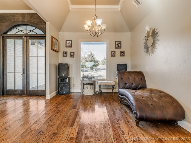 unfurnished room with wood-type flooring, vaulted ceiling, an inviting chandelier, and french doors