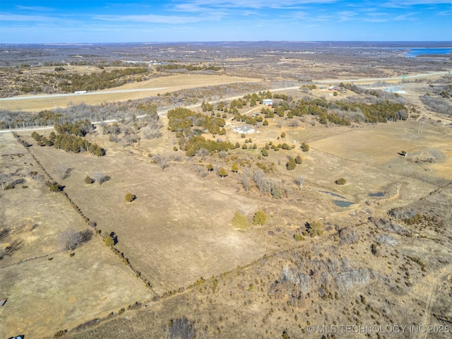 birds eye view of property with a rural view