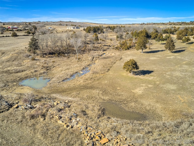 birds eye view of property featuring a rural view and a water view