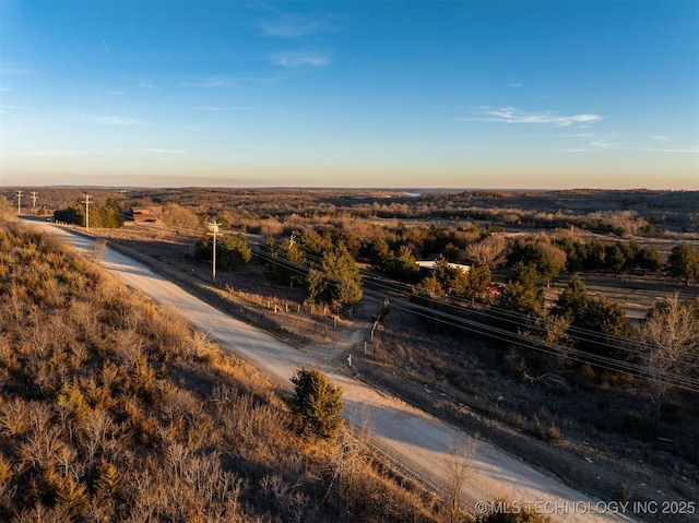 aerial view at dusk featuring a rural view