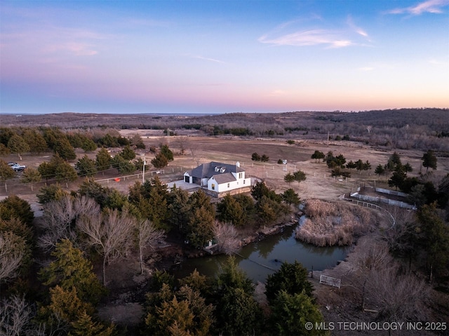 aerial view at dusk with a water view