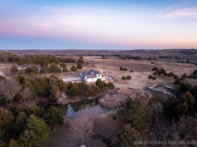 aerial view at dusk with a water view