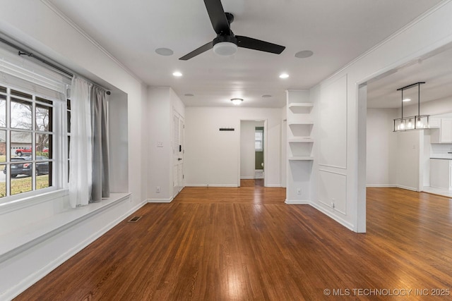 unfurnished living room with dark hardwood / wood-style floors and ceiling fan