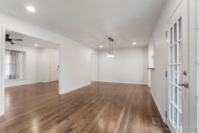 unfurnished room with ornamental molding, dark hardwood / wood-style floors, and ceiling fan