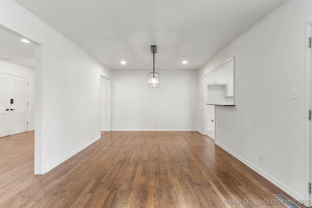 interior space with crown molding and dark hardwood / wood-style floors