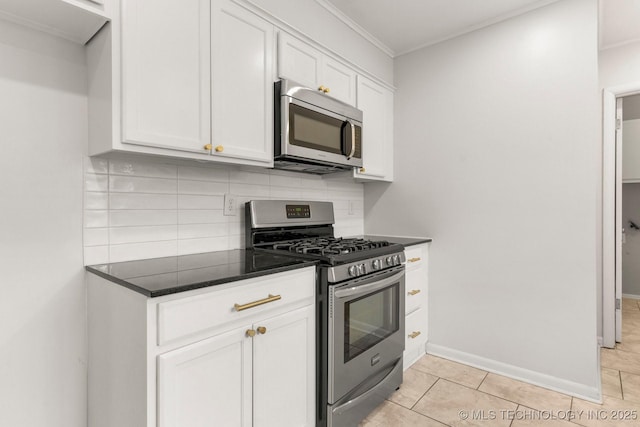 kitchen featuring light tile patterned floors, backsplash, stainless steel appliances, ornamental molding, and white cabinets