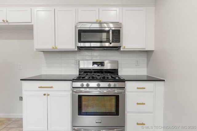 kitchen featuring tasteful backsplash, appliances with stainless steel finishes, and white cabinets