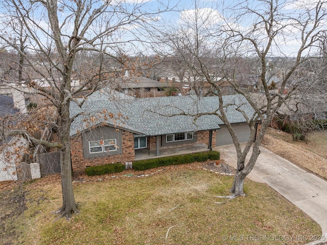 ranch-style house with a garage and a front lawn