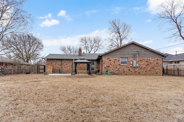 back of house with a gazebo and a yard