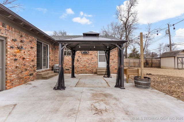 view of patio with a gazebo and a storage shed