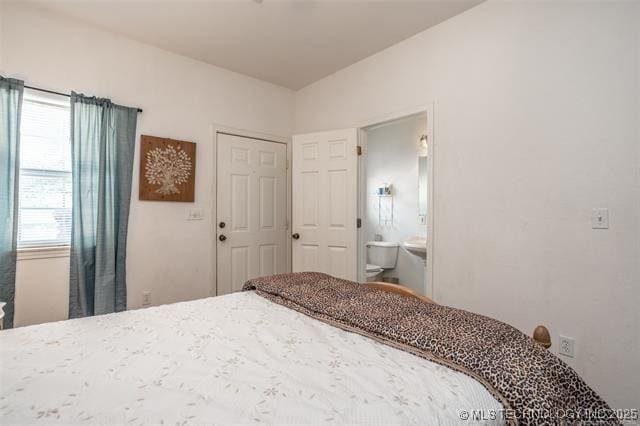 bedroom featuring connected bathroom and a closet