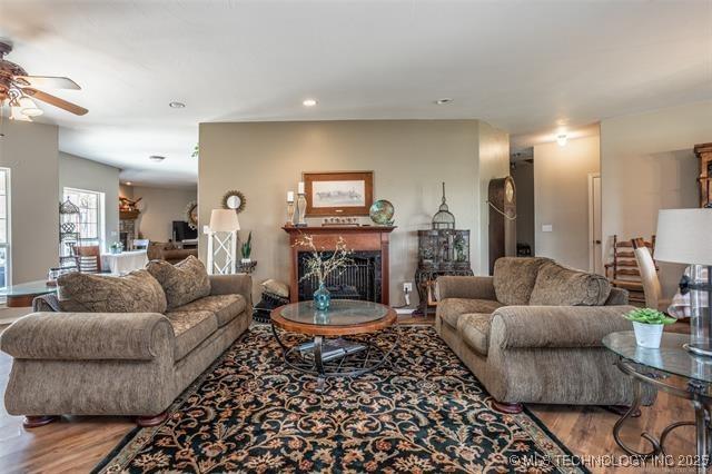 living room with hardwood / wood-style flooring and ceiling fan