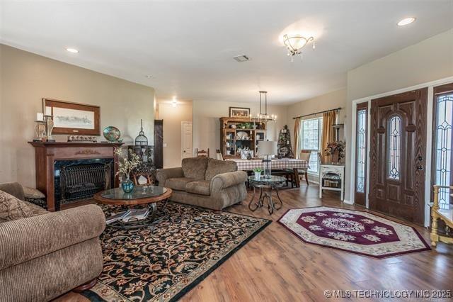 living room with an inviting chandelier and wood-type flooring