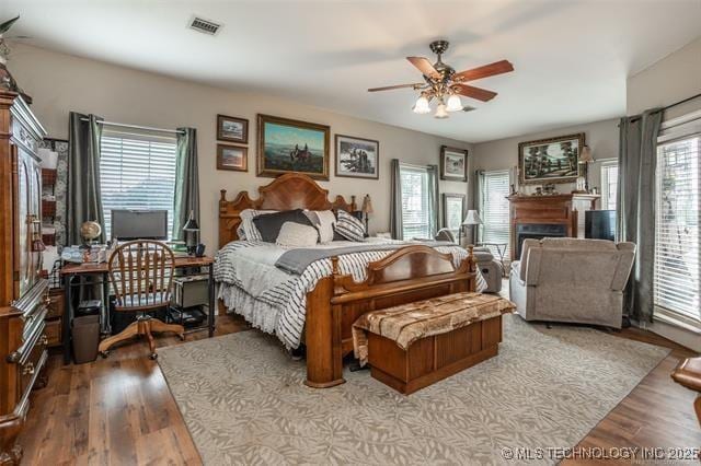 bedroom featuring multiple windows and light wood-type flooring