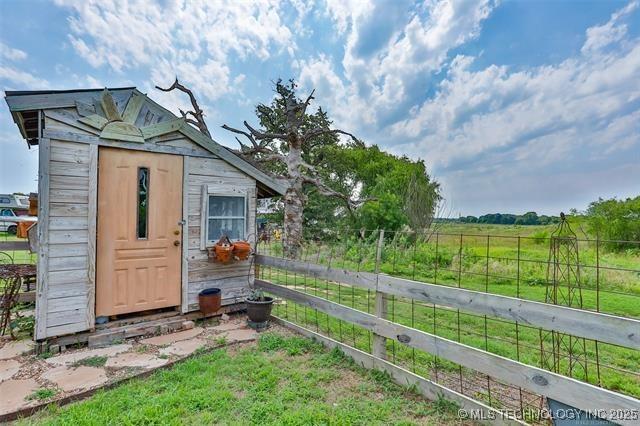 view of outbuilding featuring a rural view