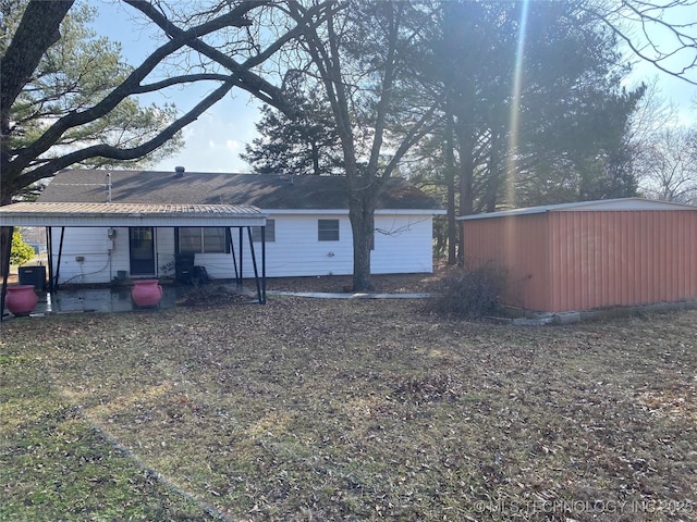 rear view of house with an outdoor structure and central air condition unit