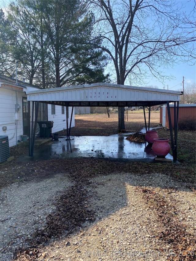 exterior space with cooling unit and a carport