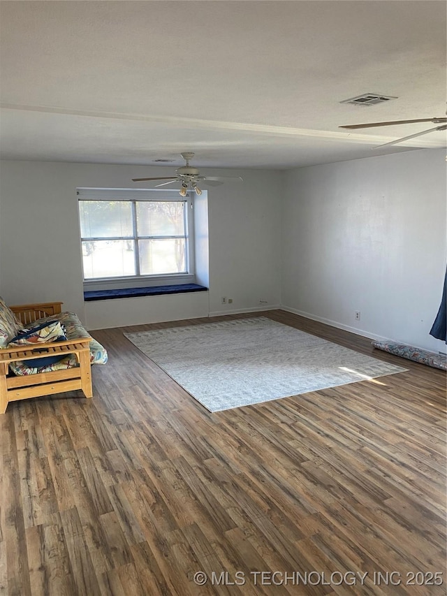 unfurnished living room featuring hardwood / wood-style flooring and ceiling fan