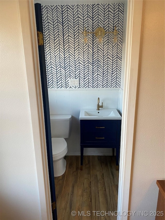 bathroom featuring vanity, toilet, and hardwood / wood-style floors