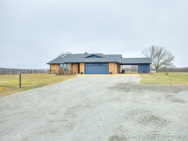 view of front facade with a garage and a front lawn