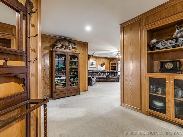 corridor with recessed lighting, wooden walls, and carpet flooring