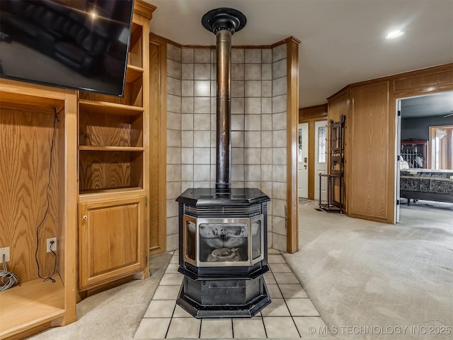 interior details with carpet flooring and a wood stove