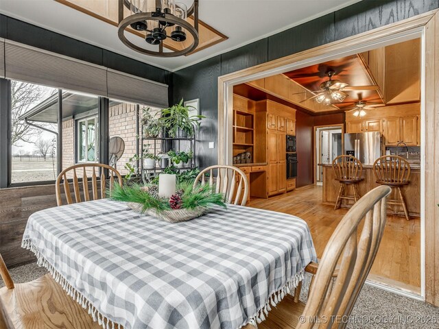 dining area featuring ceiling fan and light hardwood / wood-style flooring