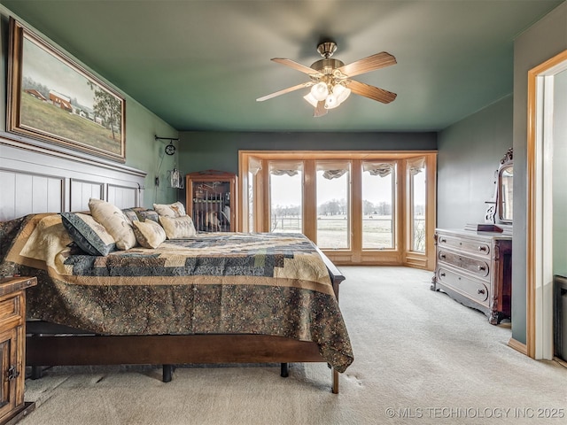 bedroom featuring light carpet and ceiling fan