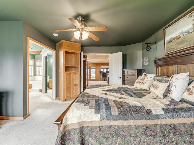 bedroom with light carpet, ceiling fan, and ensuite bathroom