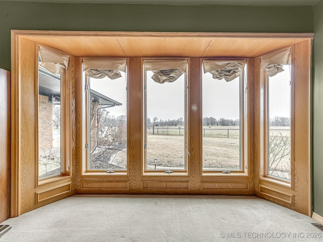 doorway to outside featuring light colored carpet